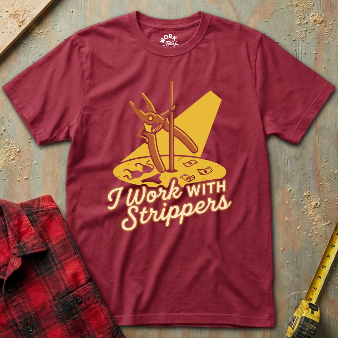 Maroon t-shirt with yellow graphic and text 'I Work With Strippers' on a textured surface.