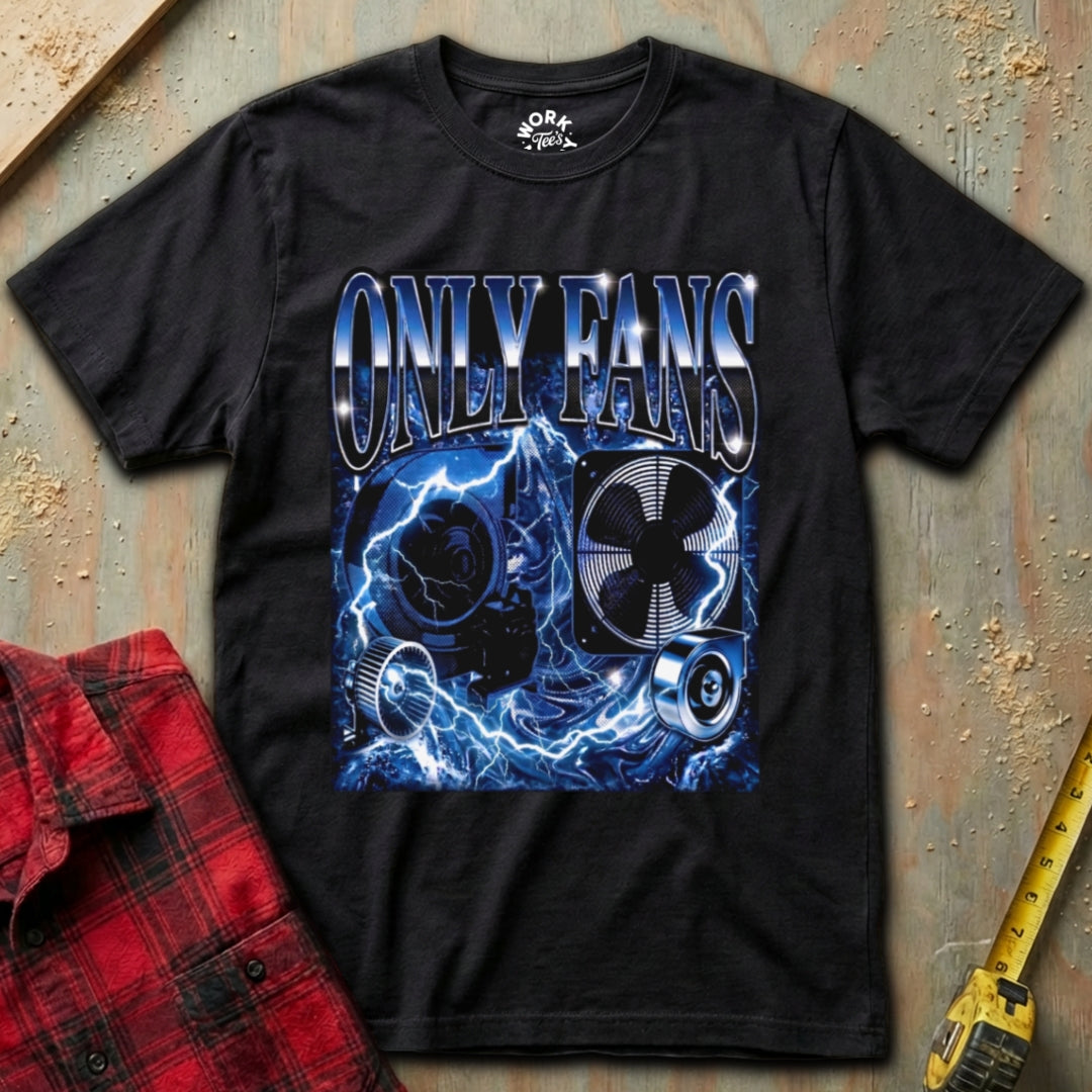 Black t-shirt with 'ONLY FANS' graphic design on a textured surface with a red plaid shirt and yellow tool in the background.