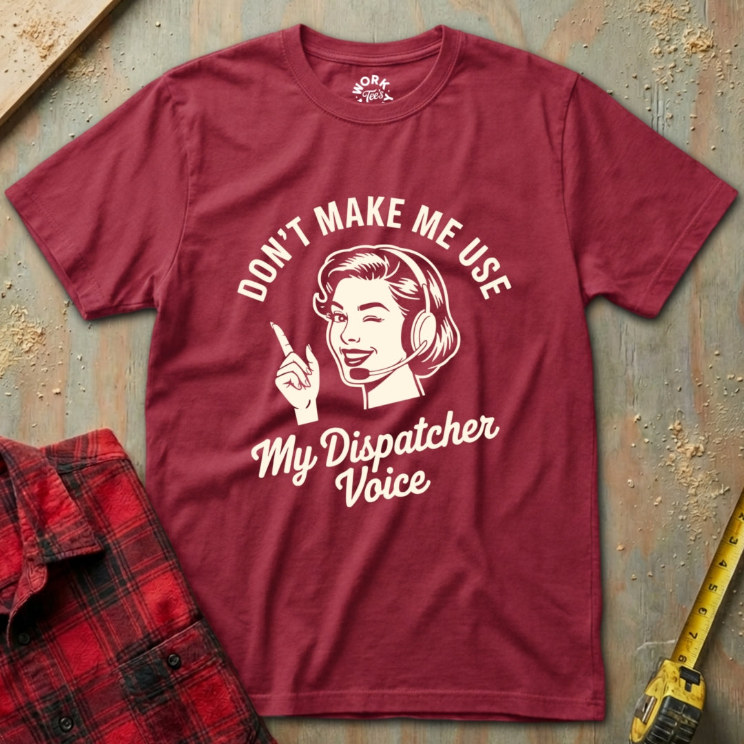 Maroon t-shirt with graphic and text 'Don't Make Me Use My Dispatcher Voice' on a textured surface.
