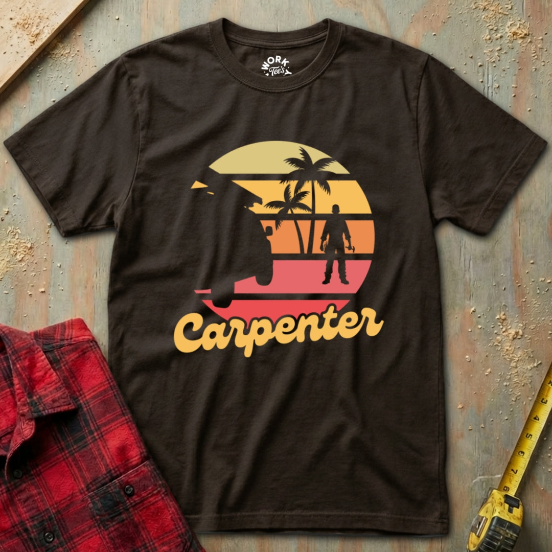 Brown t-shirt with 'Carpenter' graphic design on a textured surface with plaid shirt and tape measure.