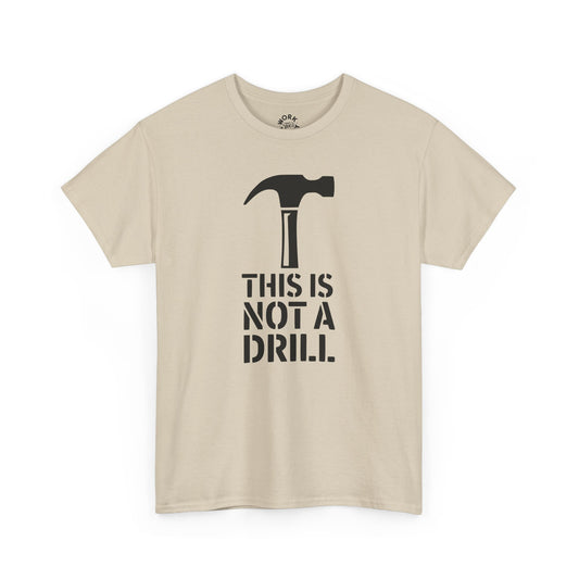 Beige t-shirt with a black hammer graphic and text 'THIS IS NOT A DRILL' on a white background