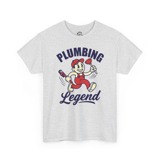 White t-shirt with cartoon character and 'Plumbing Legend' text on a white background