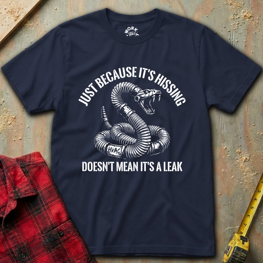 Navy blue t-shirt with a snake graphic and text on a textured surface with a red shirt and yellow tool in the background.