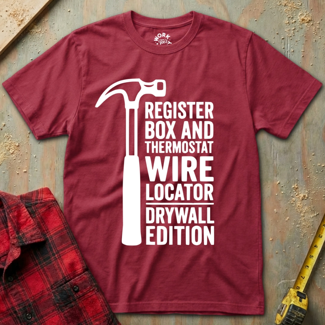 Maroon t-shirt with white graphic and text on a textured surface with tools.