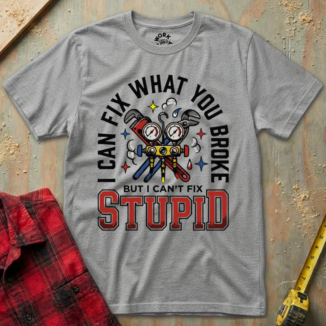 Gray t-shirt with graphic design and text on a wooden surface with tools.