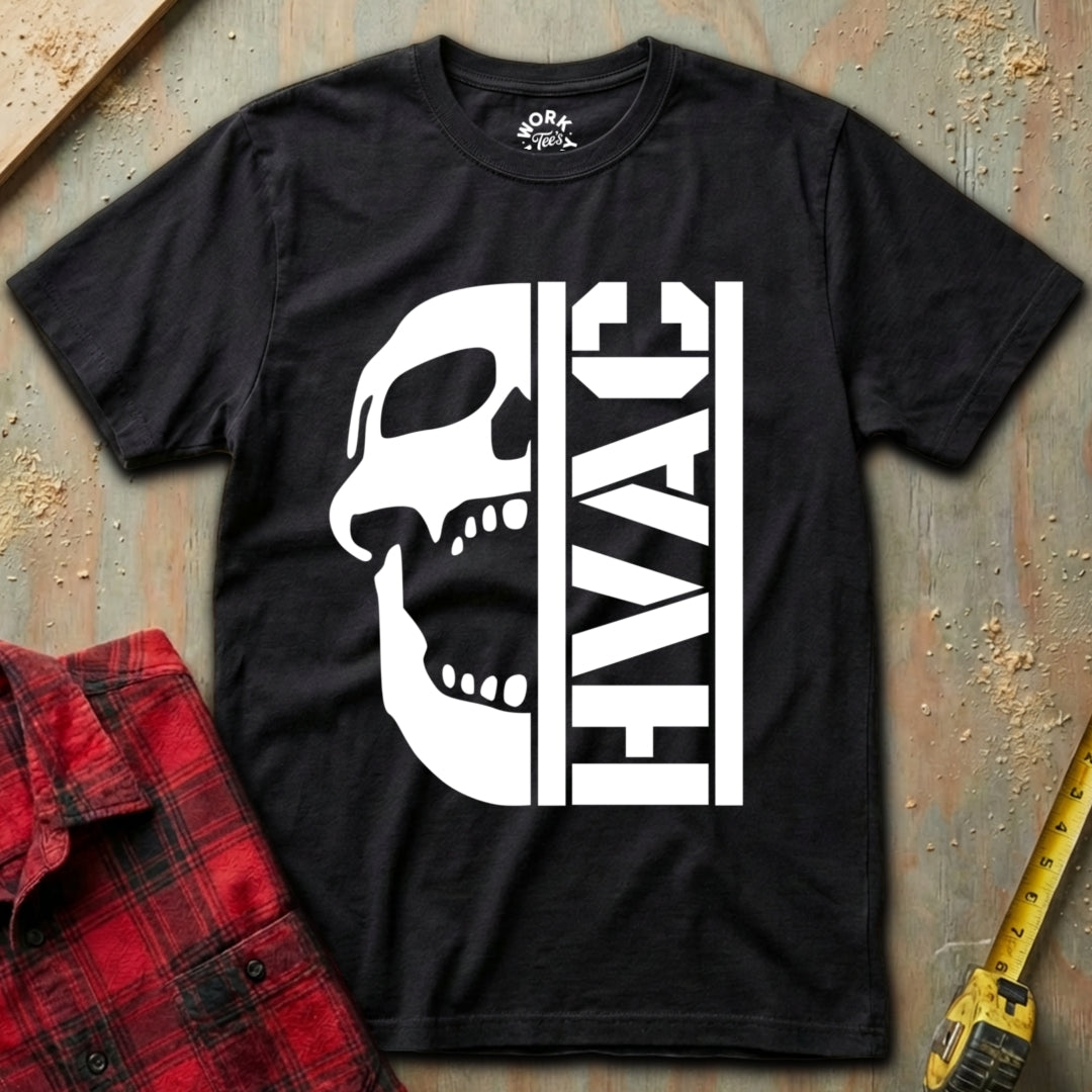 Black t-shirt with a white skull and 'HVAC' design on a textured surface with a red shirt and yellow tool in the background.