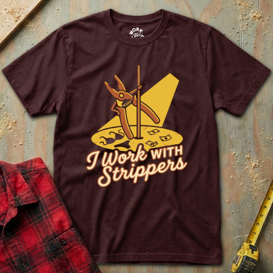 Maroon t-shirt with graphic design and text 'I Work with Strippers' on a textured surface.