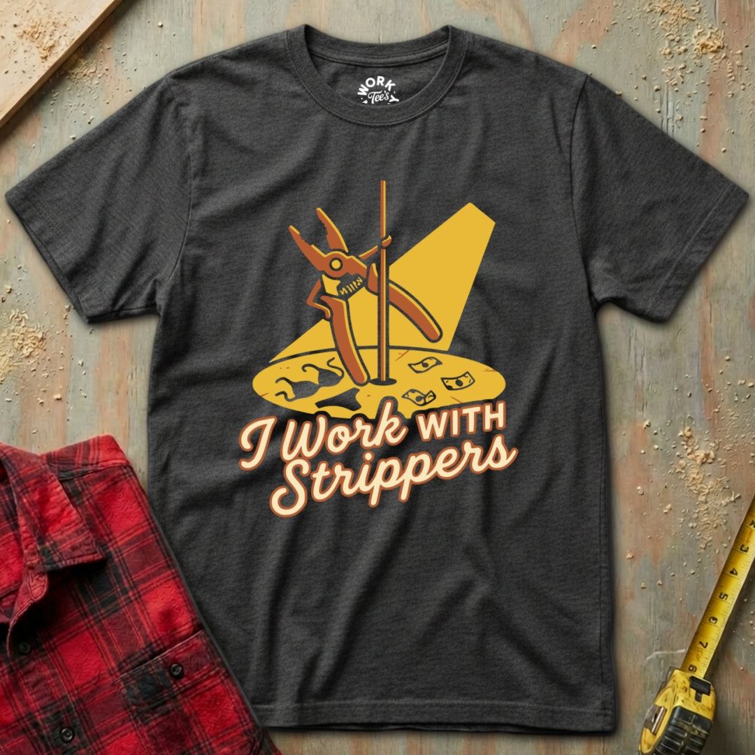Charcoal t-shirt with yellow graphic and text 'I Work with Strippers' on a textured surface.