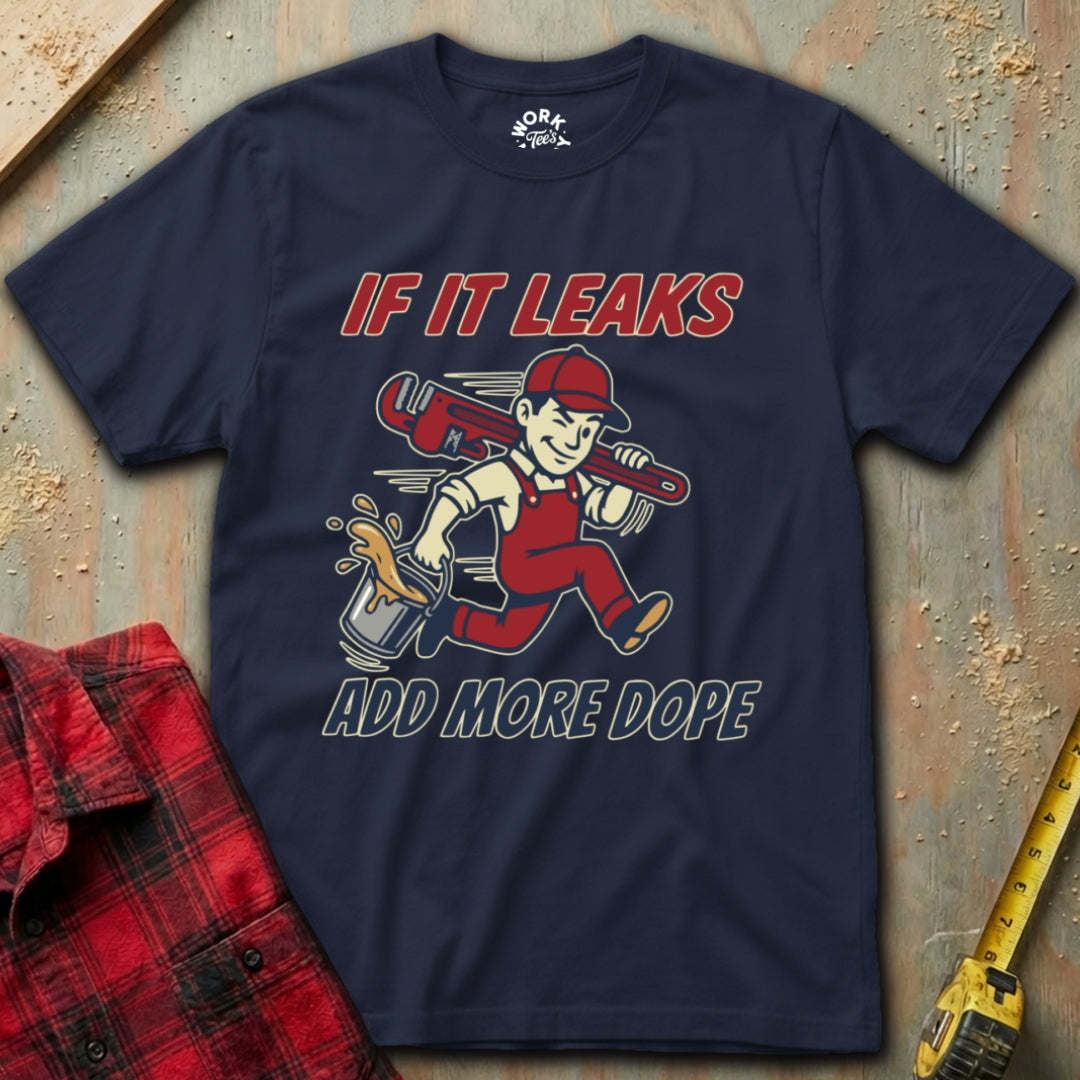 Navy blue t-shirt with graphic design and text on a textured surface with tools.