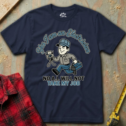Navy blue t-shirt with electrician graphic and text on a textured surface with plaid shirt and tape measure.