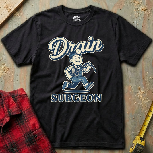 Black t-shirt with 'Drain Surgeon' graphic design on a textured surface.