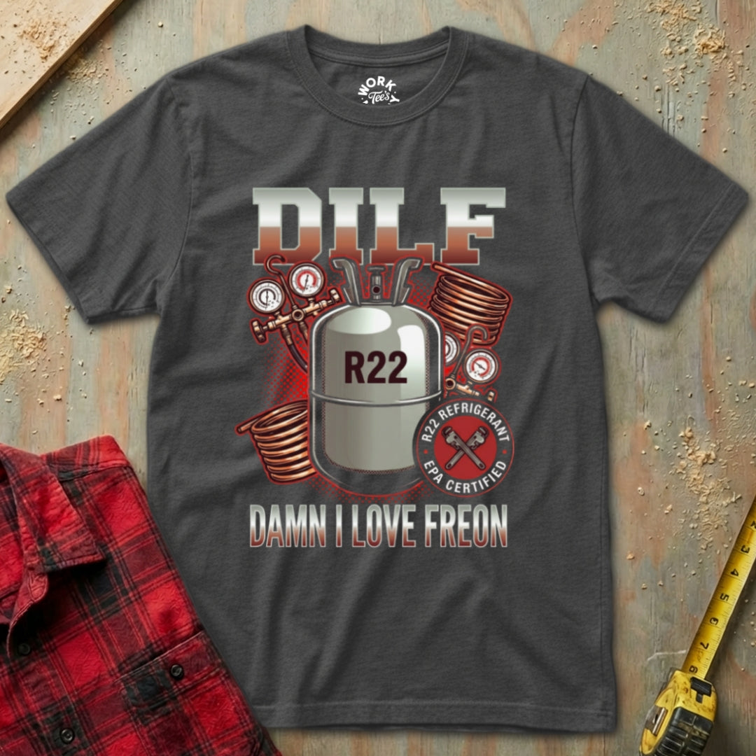 Gray t-shirt with R22 refrigerant graphic and text on a textured surface with a red flannel shirt and yellow tool in the background.