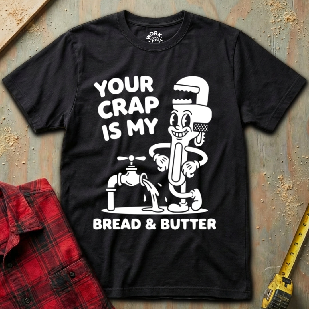 Black t-shirt with white graphic and text on a textured surface with red plaid shirt and yellow tool.