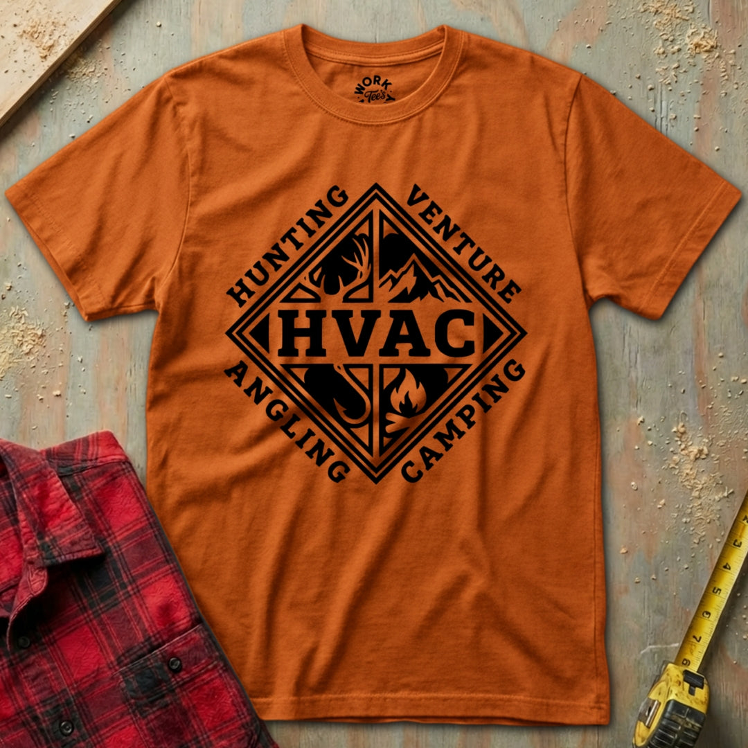 Orange t-shirt with black graphic design on a textured surface with red plaid shirt and yellow tool.