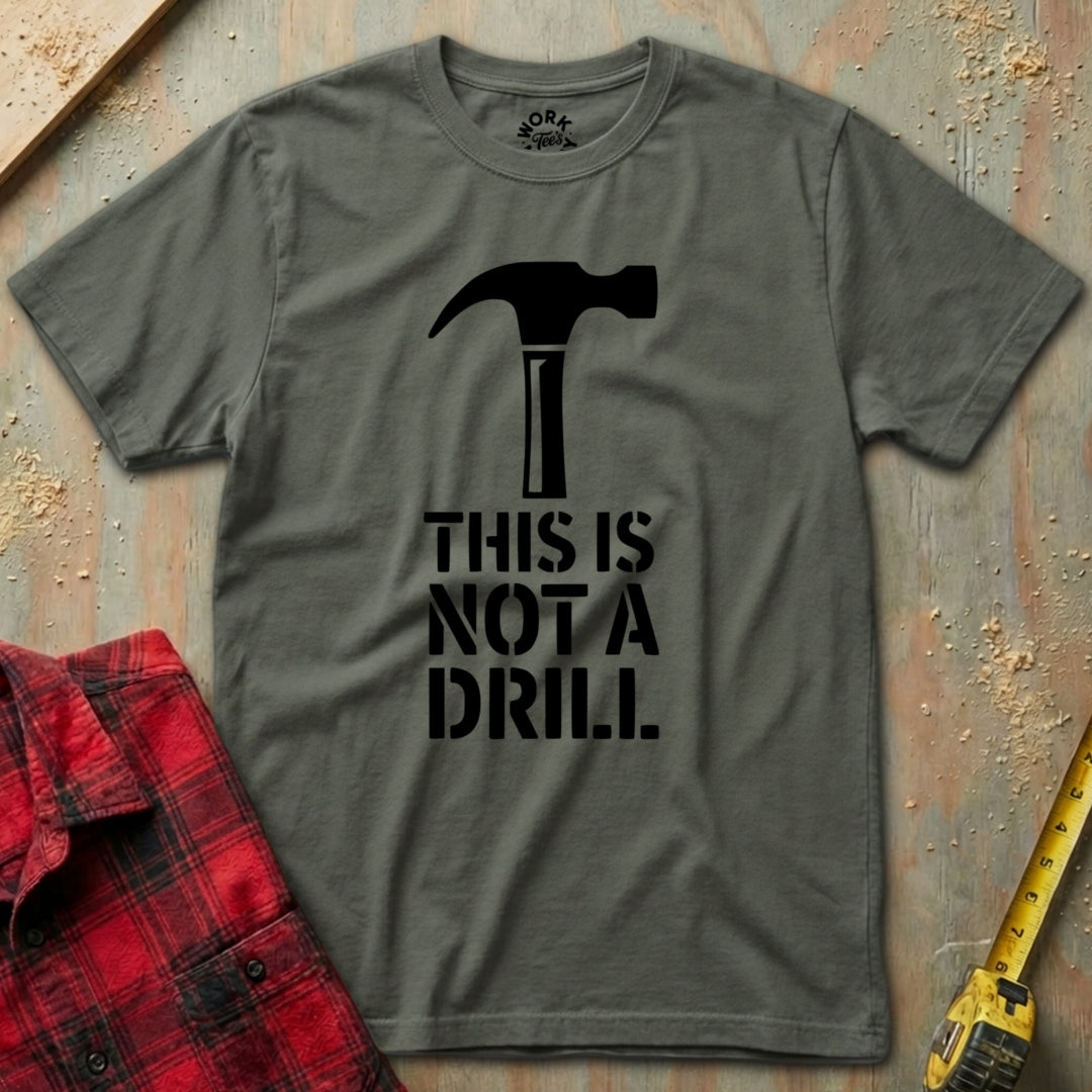 Gray t-shirt with a hammer graphic and 'This is not a drill' text on a rustic background.