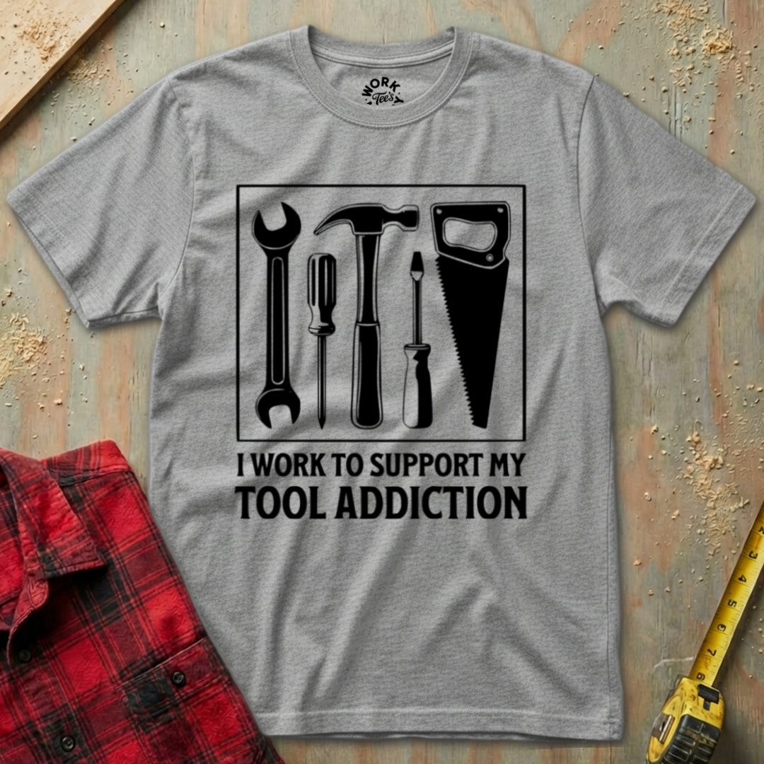 Gray t-shirt with tool graphic and text on a wooden background