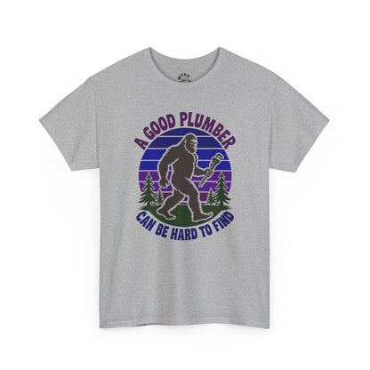 Gray t-shirt with a graphic of a bigfoot holding a wrench and text 'A good plumber can be hard to find' on a white background.
