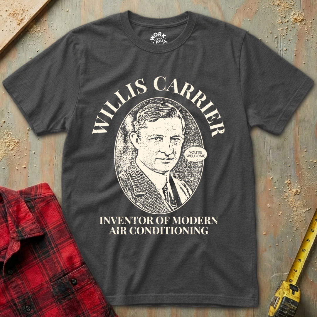 Black t-shirt with Willis Carrier design and text on a textured surface with a red plaid shirt and yellow tool in the background.
