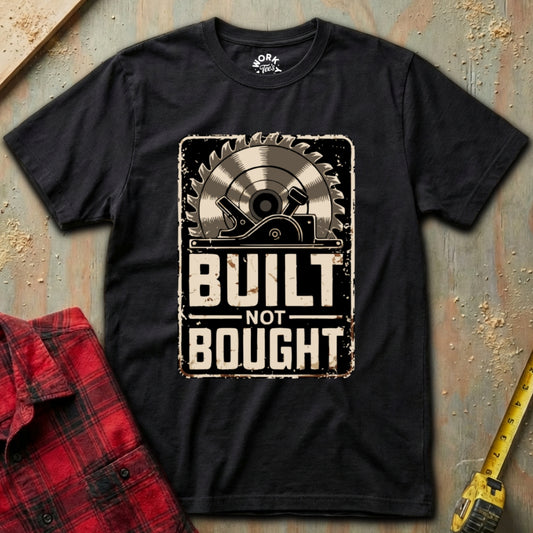 Black t-shirt with 'Built Not Bought' graphic design on a rustic background