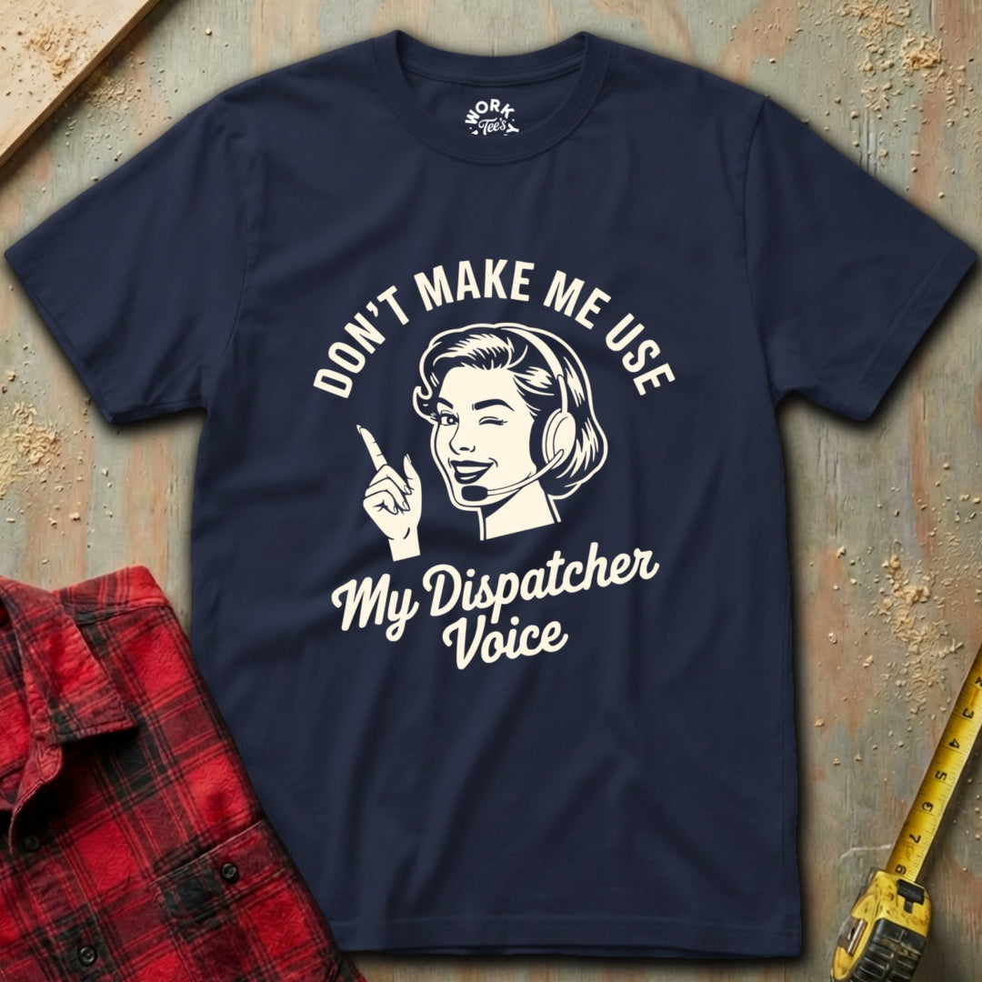 Navy blue t-shirt with graphic and text on a textured surface with red plaid shirt and yellow tool in background