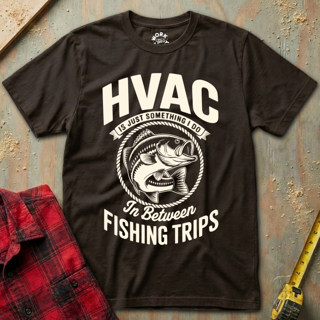 Brown t-shirt with HVAC fishing graphic on a textured surface