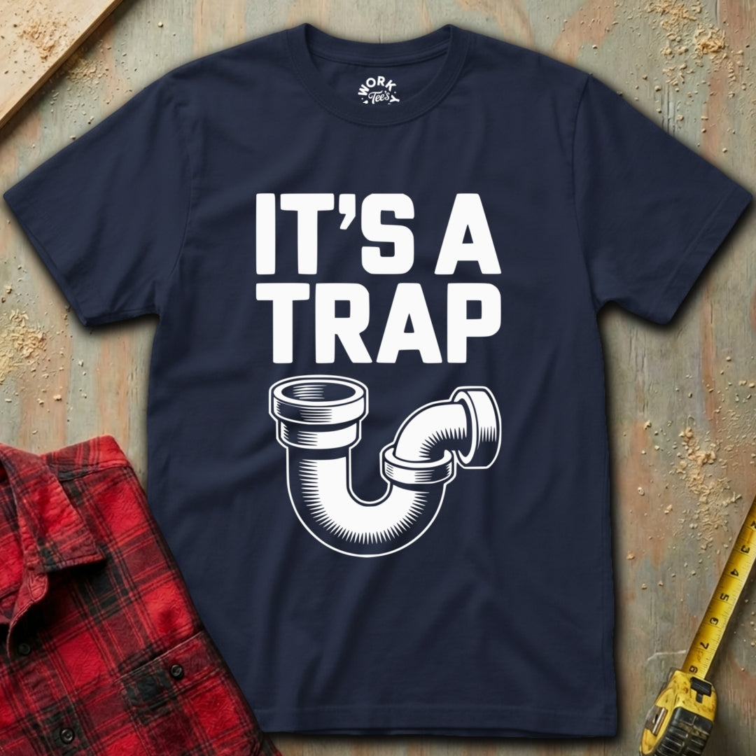Navy blue t-shirt with 'It's a Trap' graphic and plaid shirt and tape measure on a textured surface