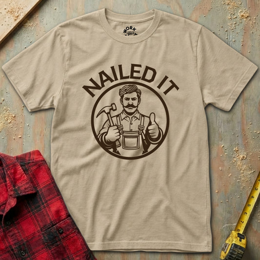 Beige t-shirt with 'NAILED IT' graphic on a rustic wooden background