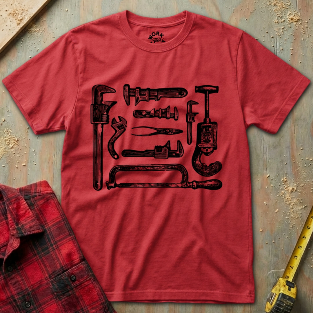 Red t-shirt with black tool graphic on a textured surface