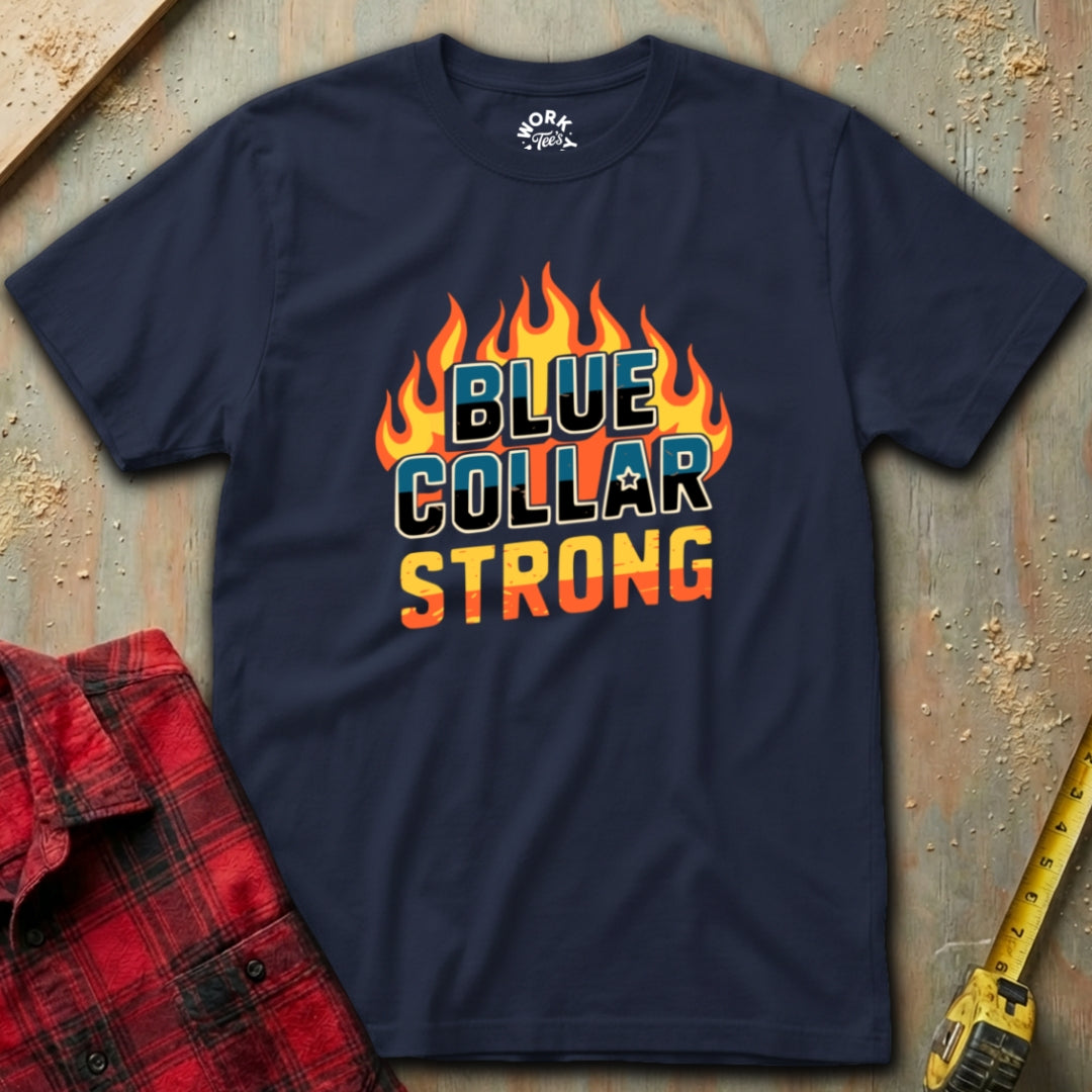 Navy blue t-shirt with 'Blue Collar Strong' text on a textured surface with plaid shirt and tape measure.