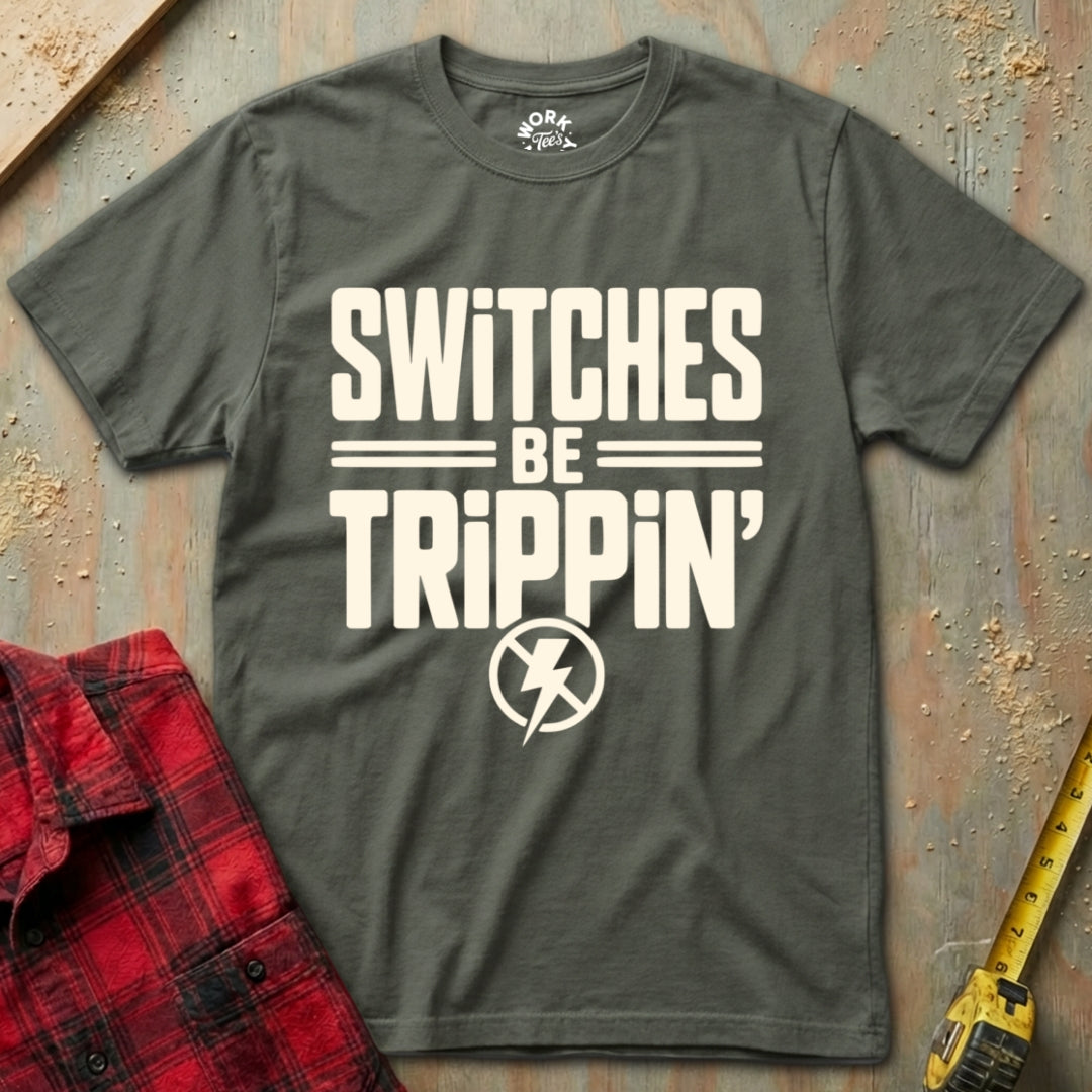 Gray t-shirt with 'SWITCHES BE TRIPPIN'' text on a rustic background