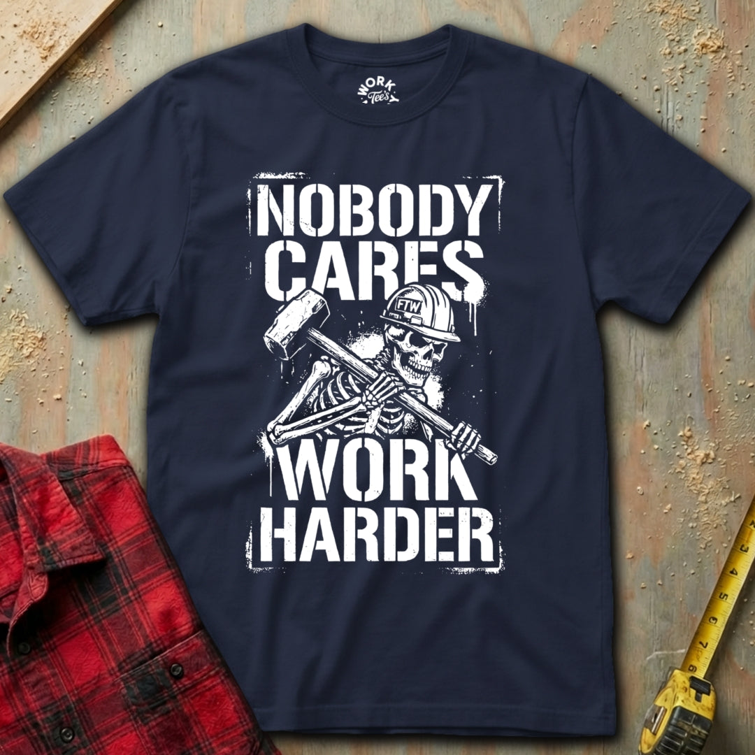 Navy blue t-shirt with skeleton graphic and text 'Nobody Cares Work Harder' on a textured surface.